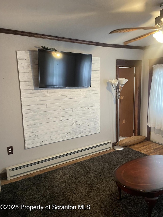 841 Hill St, Archbald, PA 18403 - living room with a ceiling fan, a baseboard heating unit, and crown molding