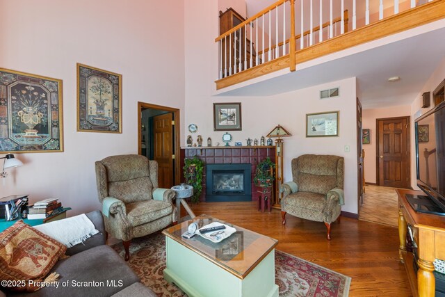 1200 Merion Cir, Clarks Summit, PA 18411 - living area featuring a high ceiling, a tile fireplace, and wood finished floors