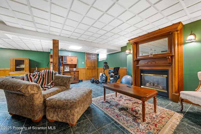 1200 Merion Cir, Clarks Summit, PA 18411 - living room with wainscoting, a fireplace, and wooden walls