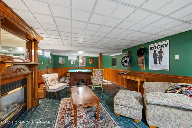 1200 Merion Cir, Clarks Summit, PA 18411 - living area featuring a wainscoted wall, wood walls, a glass covered fireplace, pool table, and tile patterned flooring