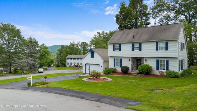 1200 Merion Cir, Clarks Summit, PA 18411 - colonial home featuring asphalt driveway, a front yard, a mountain view, a shingled roof, and a garage