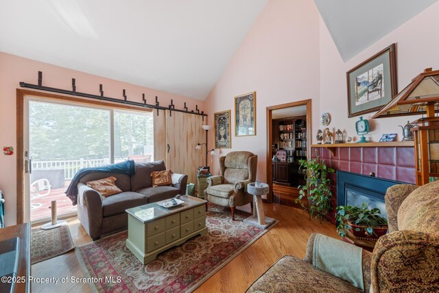 1200 Merion Cir, Clarks Summit, PA 18411 - living room featuring a fireplace, wood finished floors, and high vaulted ceiling