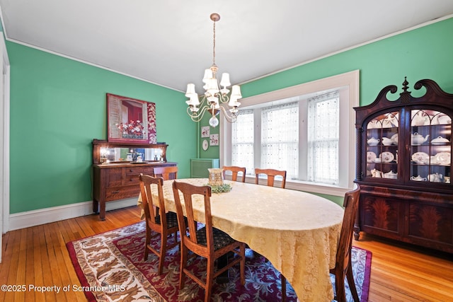 1012 Sunset St, Scranton, PA 18509 - dining area featuring a chandelier, wood-type flooring, and ornamental molding