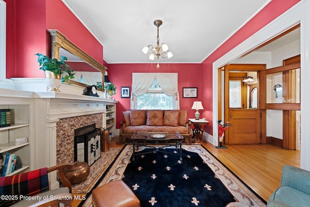 1012 Sunset St, Scranton, PA 18509 - living area with a chandelier, wood finished floors, a premium fireplace, and ornamental molding