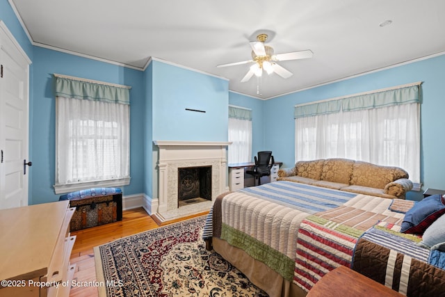 1012 Sunset St, Scranton, PA 18509 - bedroom featuring wood finished floors, ornamental molding, a ceiling fan, and a premium fireplace