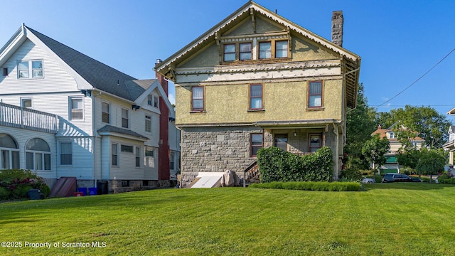 1012 Sunset St, Scranton, PA 18509 - back of house with a lawn, a chimney, stucco siding, and stone siding