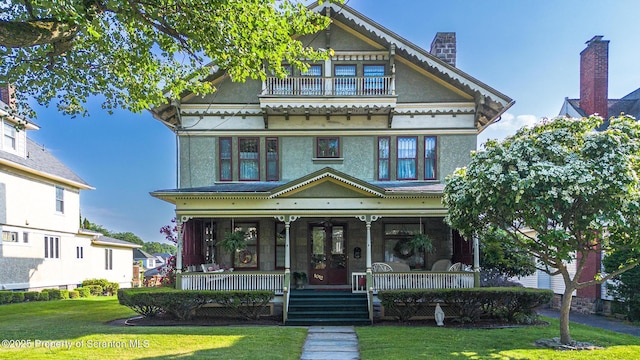 1012 Sunset St, Scranton, PA 18509 - victorian house with covered porch, a front lawn, a balcony, and a chimney