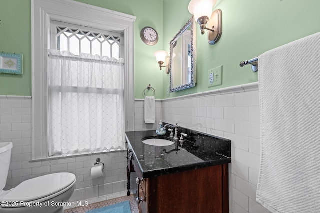 1012 Sunset St, Scranton, PA 18509 - bathroom with tile walls, a wainscoted wall, and vanity