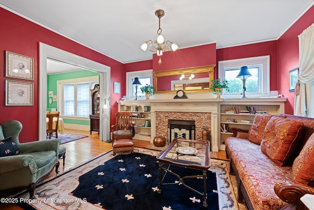1012 Sunset St, Scranton, PA 18509 - living area featuring a chandelier, wood finished floors, a fireplace, and ornamental molding