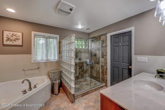 993 Oakmont Rd, Clarks Summit, PA 18411 - full bathroom featuring tile walls, a stall shower, a bath, vanity, and tile patterned flooring