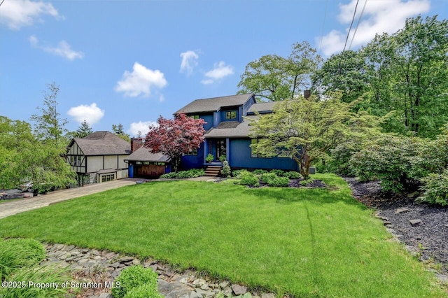 993 Oakmont Rd, Clarks Summit, PA 18411 - view of front of house featuring a front lawn, a garage, and a shingled roof