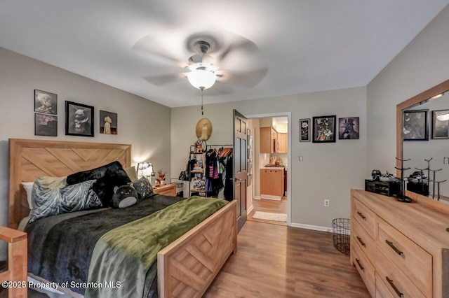 993 Oakmont Rd, Clarks Summit, PA 18411 - bedroom featuring dark wood-style floors, baseboards, ceiling fan, and ensuite bathroom