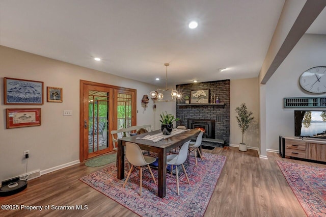 993 Oakmont Rd, Clarks Summit, PA 18411 - dining area featuring wood finished floors, baseboards, a fireplace, recessed lighting, and a chandelier