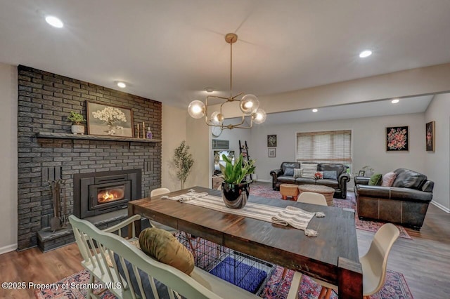 993 Oakmont Rd, Clarks Summit, PA 18411 - dining room with wood finished floors, baseboards, a brick fireplace, recessed lighting, and a chandelier