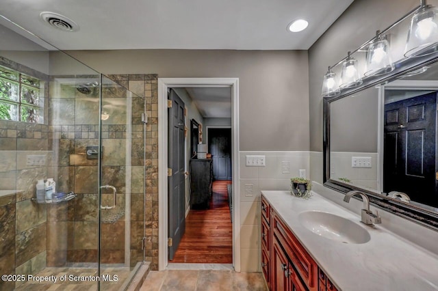 993 Oakmont Rd, Clarks Summit, PA 18411 - full bath featuring vanity, a stall shower, tile walls, and wainscoting