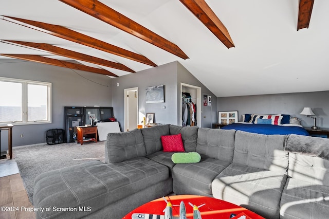 living room with carpet floors and lofted ceiling with beams