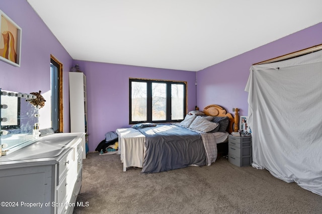 bedroom featuring light carpet