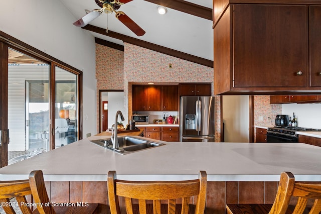 kitchen with stainless steel refrigerator with ice dispenser, vaulted ceiling with beams, sink, black gas stove, and a breakfast bar area