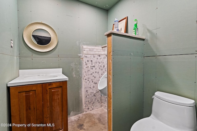 bathroom with toilet, concrete flooring, and vanity