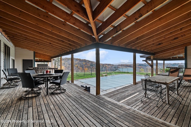 deck with a water and mountain view