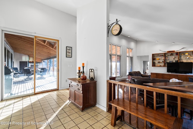 interior space with lofted ceiling and light tile patterned floors