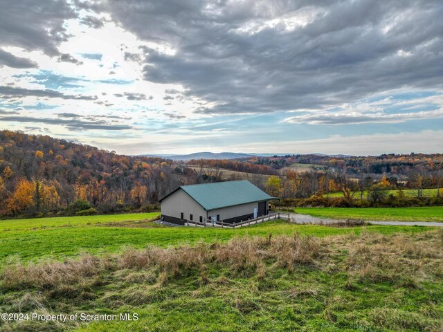 exterior space with a rural view and a mountain view