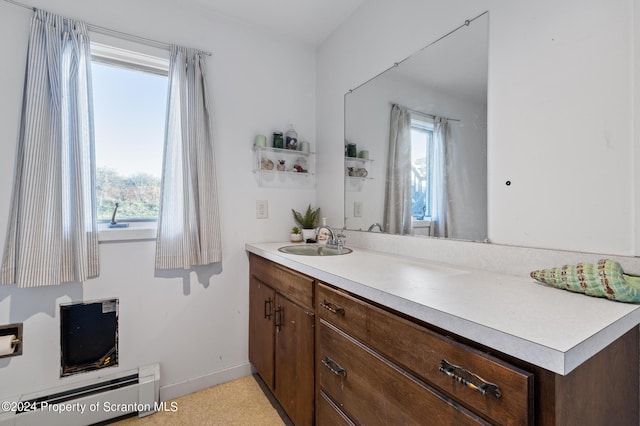 bathroom with vanity and baseboard heating