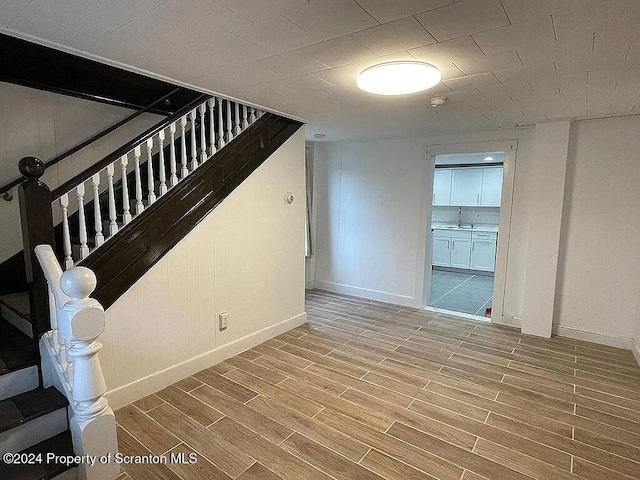 interior space featuring wood-type flooring and sink