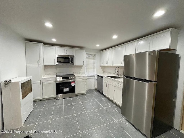 kitchen with white cabinets, stainless steel appliances, and sink