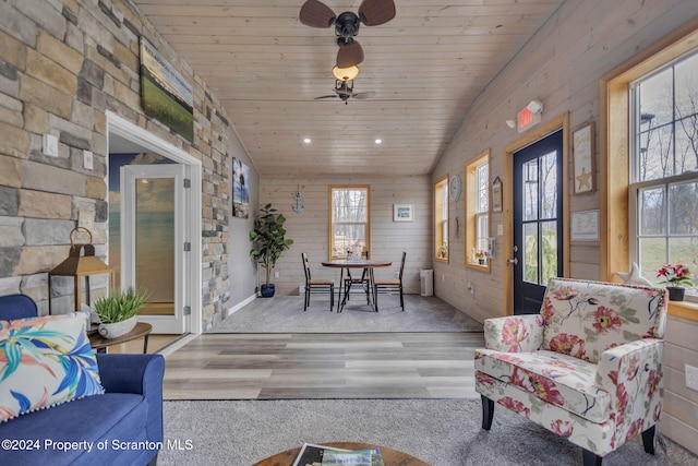 sunroom with ceiling fan, lofted ceiling, and wood ceiling