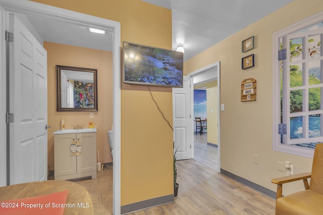 hall with light hardwood / wood-style flooring