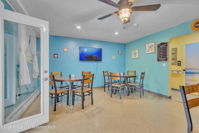 dining space featuring ceiling fan and a baseboard heating unit