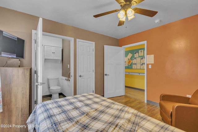 bedroom with ceiling fan, light wood-type flooring, ensuite bathroom, and a closet