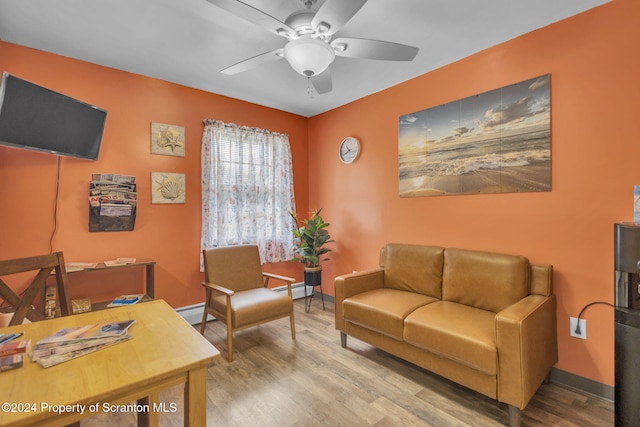 office space featuring ceiling fan, wood-type flooring, and a baseboard heating unit