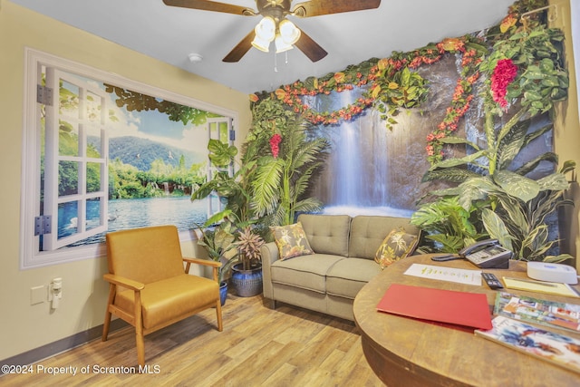 sitting room with light hardwood / wood-style floors and ceiling fan