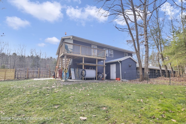 back of house featuring a yard and a wooden deck