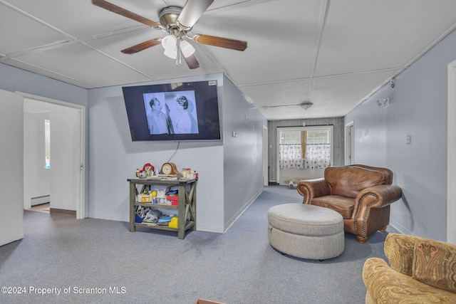 sitting room with ceiling fan and a baseboard radiator