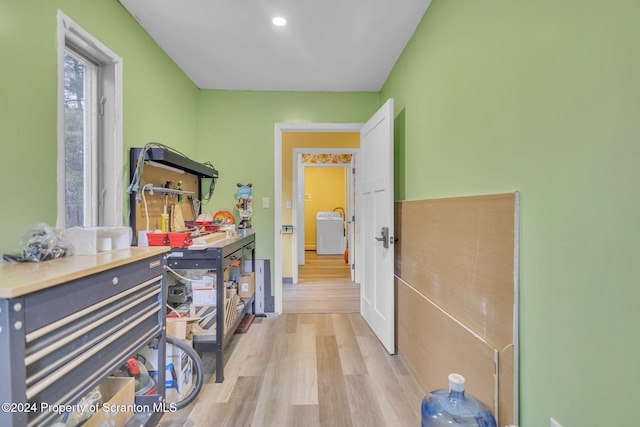 corridor featuring washer / dryer and light hardwood / wood-style flooring