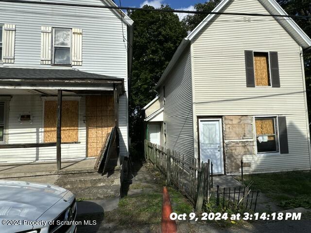 view of side of home with a porch