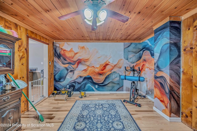 interior space featuring ornamental molding, light wood-type flooring, ceiling fan, and wooden ceiling