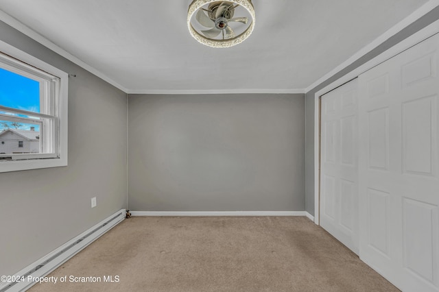 unfurnished bedroom featuring light carpet, a baseboard radiator, a closet, and ornamental molding