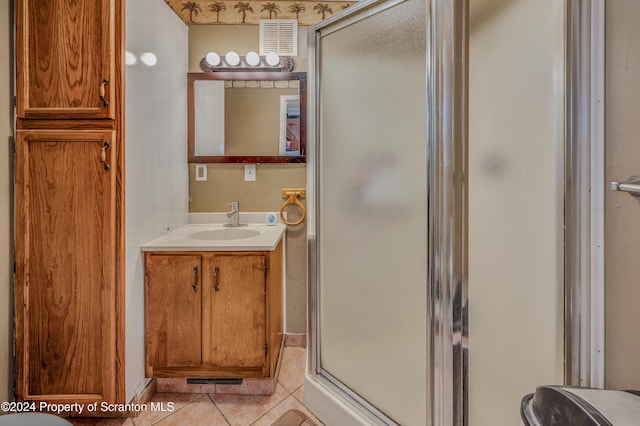 bathroom featuring tile patterned flooring, vanity, and an enclosed shower