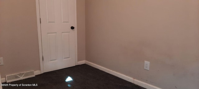 empty room with dark carpet
