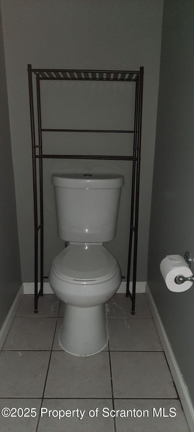 bathroom with tile patterned flooring and toilet