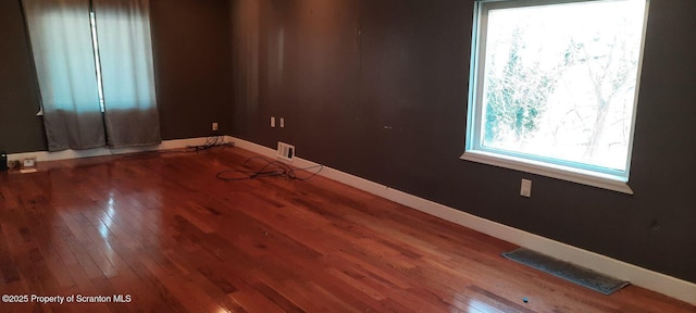 empty room with hardwood / wood-style floors