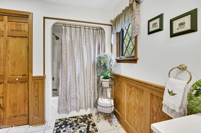 bathroom with tile patterned flooring and shower / bath combination with curtain