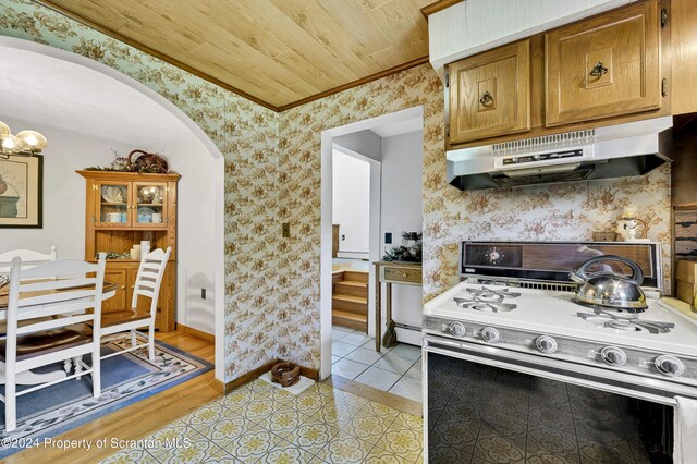 kitchen with wood ceiling, white stove, light tile patterned floors, and a baseboard radiator