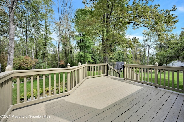 wooden deck with a lawn