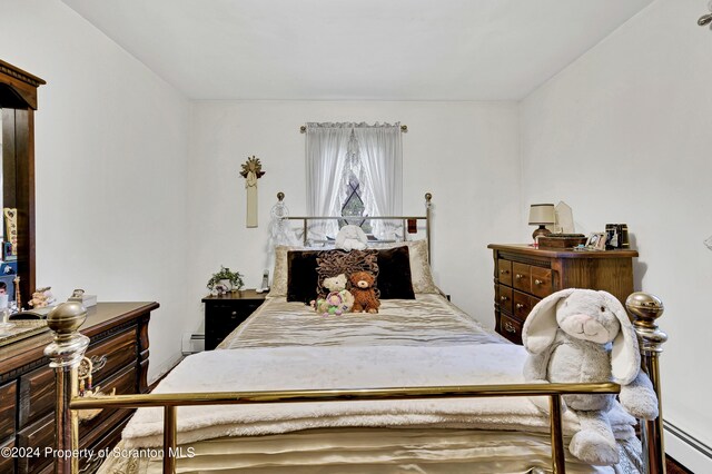 bedroom featuring a baseboard heating unit