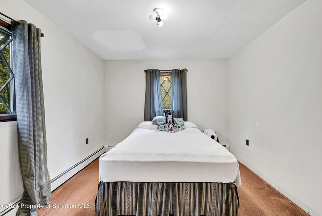 bedroom with carpet floors and baseboard heating